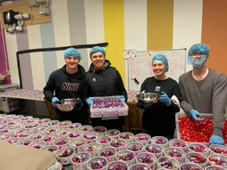 four workers in a chocolate factory